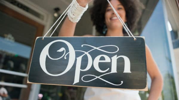 Girl Holding Business Open Sign